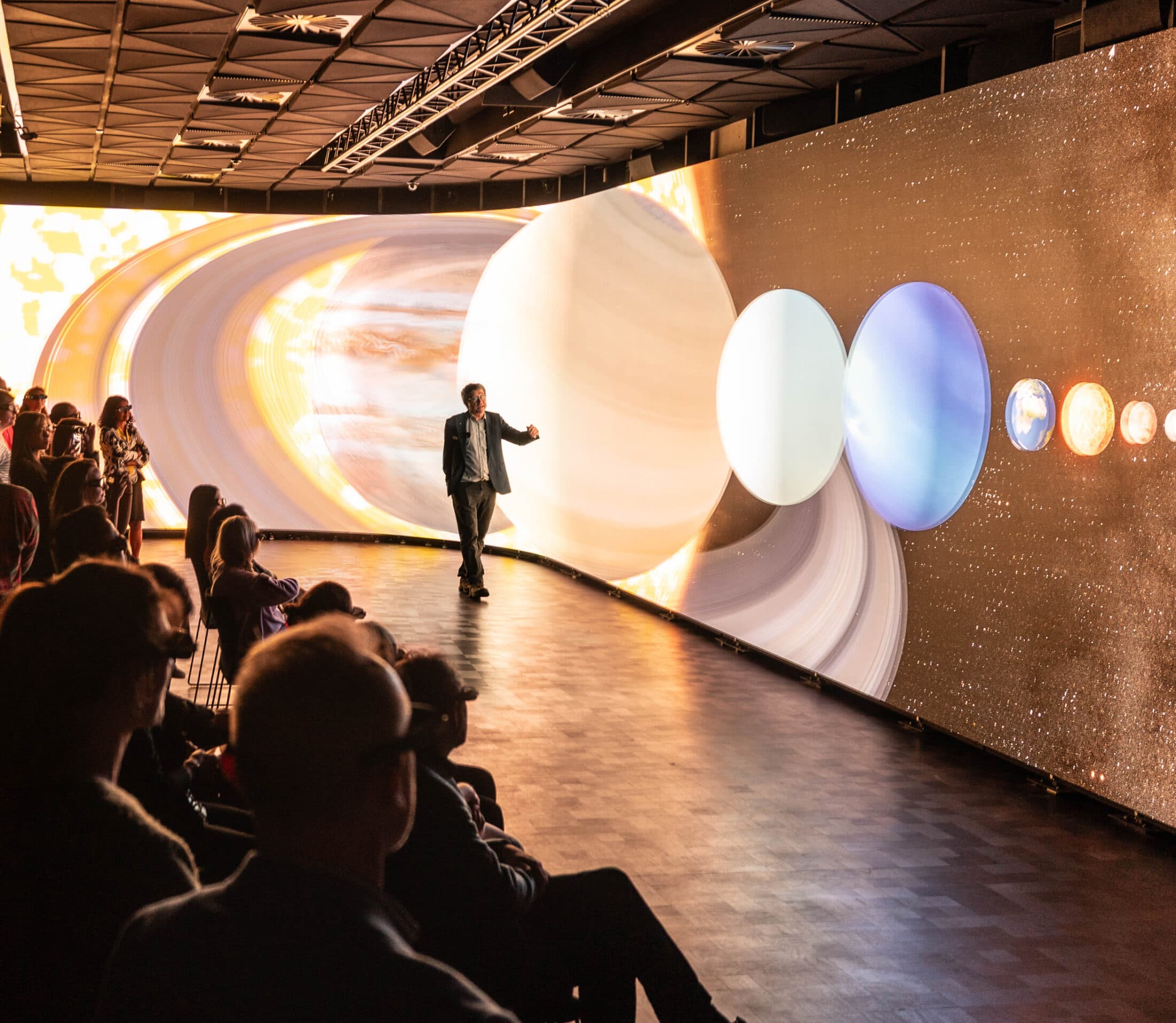 Presenter with Saturn rings on the SVU LED wall